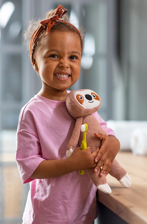 Happy Child Holding Educational Toy During Learning Session